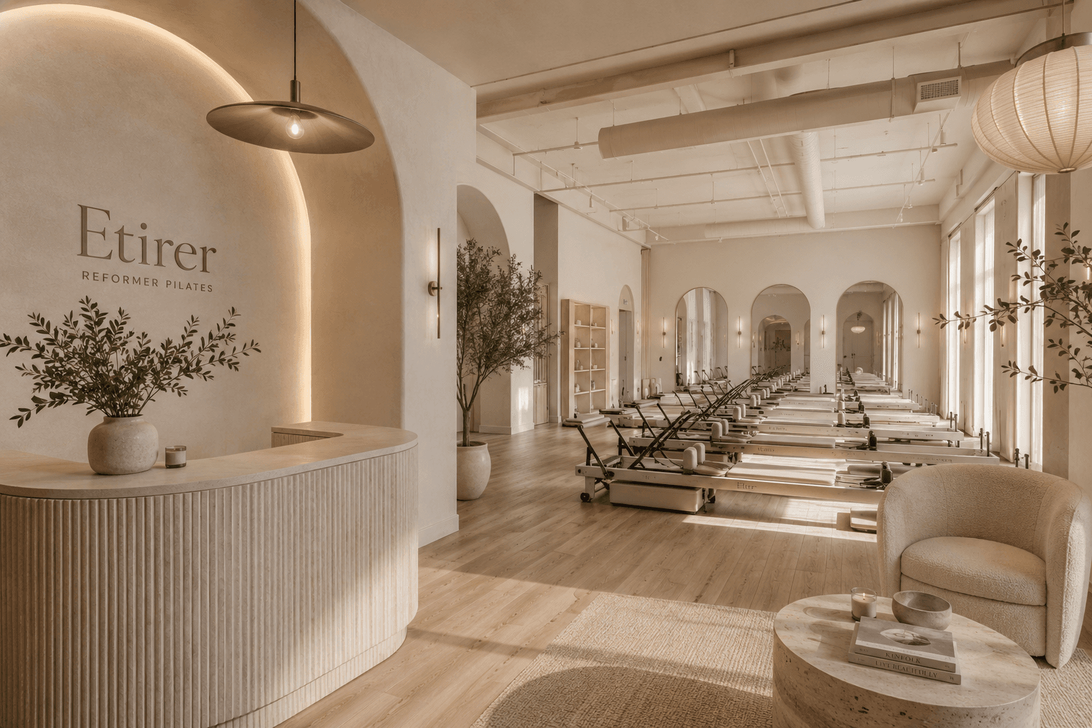 The Etirer reception and reformer studio — warm, arched, sunlit.